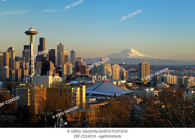City skyline at sunset with the Space Needle, downtown and Mount Rainier from Queen Anne Hill; Seattle, Washington