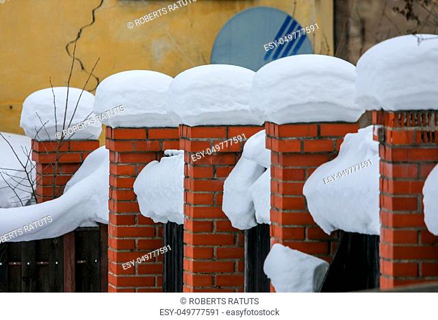 Brick wall, covered with snow in January in Cesis, Latvia