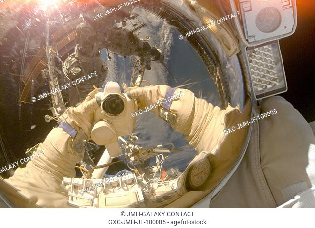 Russian Federal Space Agency cosmonaut Oleg Kononenko, Expedition 17 flight engineer, uses a digital camera to expose a photo of his helmet visor during a...