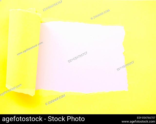 Torn yellow paper isolated on pastel pink