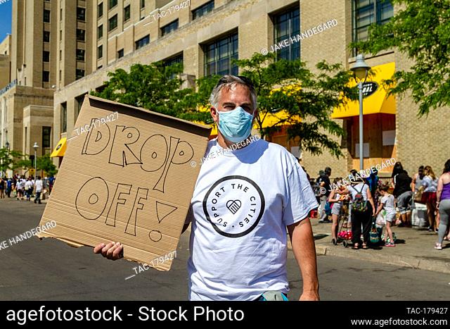 Minneapolis, MN - May 31, 2020: Crowds gather outside Midtown Global Market for food and supplies at the aftermath scene of the George Floyd Black Lives Matter...