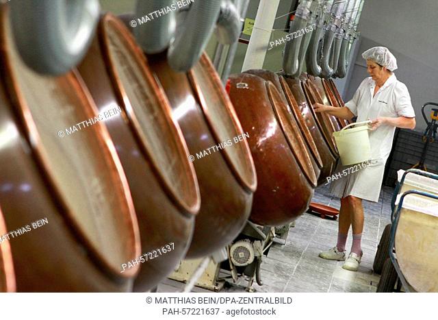 Rotating copper kettles are used to produce fruit candy in Oschersleben, Germany, 23 March 2015. The company manufactured 4700 metric tonnes of sweets in 2014