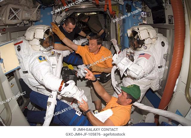 As the mission's third spacewalk draws to a close, astronauts Robert L. Curbeam, Jr. (left), STS-116 mission specialist, and Sunita L