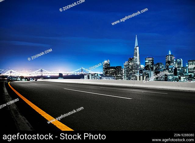 empty asphalt road with cityscape and skyline of san francisco at twilight