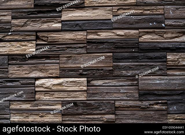 Natural stone bricks as a decoration on a wall. Natural stone wall texture. The walls are made of stones or marbles. Decoration for the walls or febces