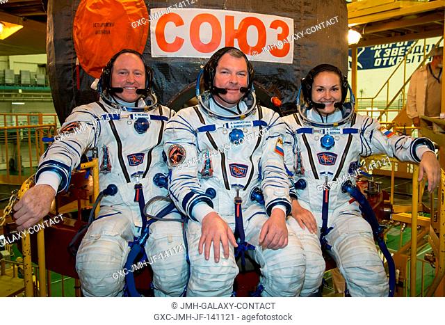 At the Baikonur Cosmodrome in Kazakhstan and clad in their Russian Sokol launch and entry suits, Expedition 41 Flight Engineer Barry Wilmore of NASA (left)