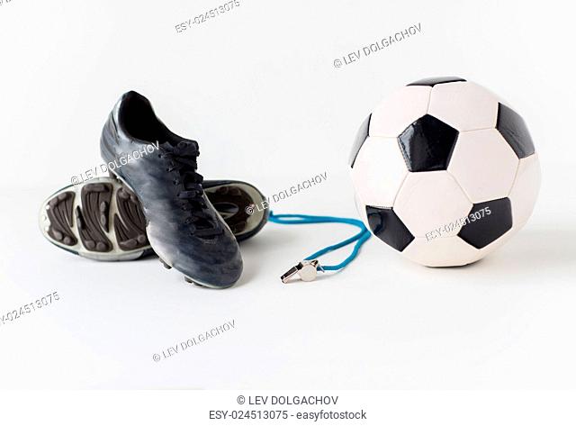 sport, soccer, football and sports equipment concept - close up of ball, referee whistle and boots