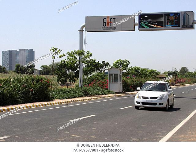 Cars drive under a road sign for -GIFT - Gujarat International Finance Tec-City- in Gandhinagar, India, 16 May 2015. The 358 hectare site is intended to become...