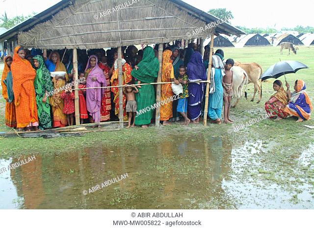 Women waiting for flood relief in a flood shelter centre Gaibandha, Bangladesh July 21, 2004