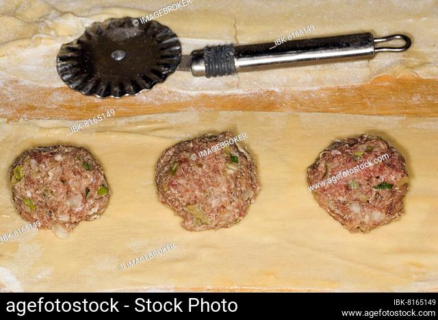 Maultaschen filling of beef and pork meat on a thin pasta dough