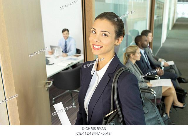 Businesswoman smiling in office doorway