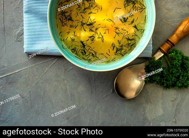 Healthy food concept with chicken soup on rustic background with copy space