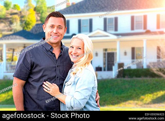 Happy Couple In Front of Beautiful House