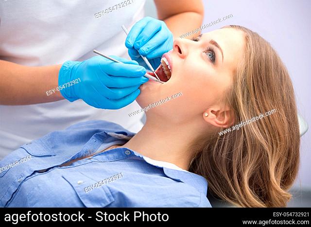 Girl with beautiful white teeth on reception at the doctor dentist