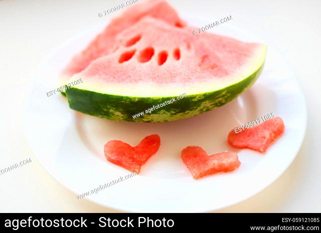 on the plate are two pieces of watermelon and a small heart-shaped