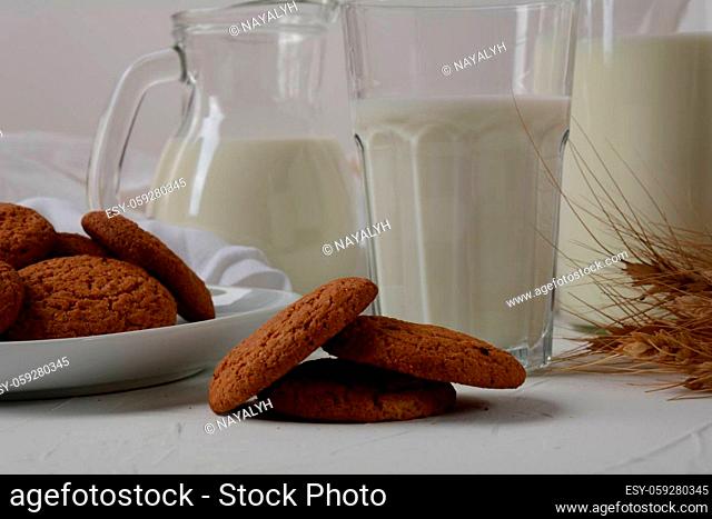 Chocolate chip cookies with milk on white background