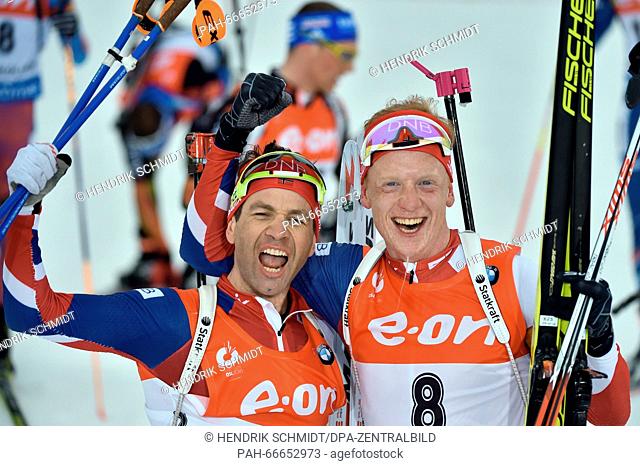 Ole Einar Bjoerndalen (L) of Norway celebrates with Johannes Thingnes Boe of Norway after the Men 15km Mass Start competition at the Biathlon World...
