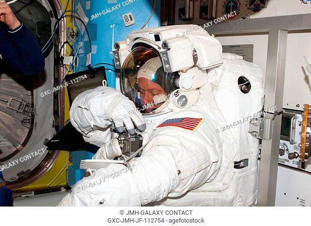 NASA astronaut Michael Fincke, STS-134 mission specialist, attired in an Extravehicular Mobility Unit (EMU) spacesuit, prepares for the start of the mission's...