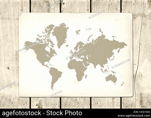 Antique vintage world map parchment on a wooden wall