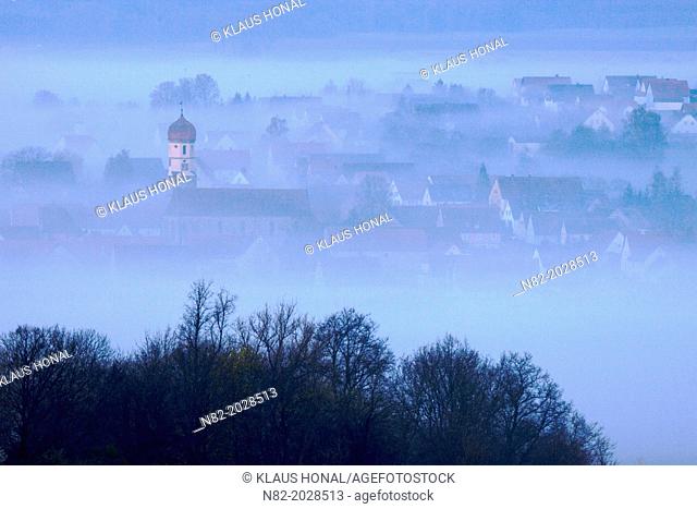 View from Hesselberg mountain on a small Bavarian village in fog - Region Hesselberg, Bavaria/Germany