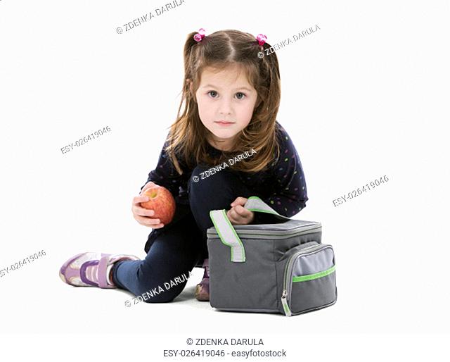 little girl holding bag with her lunch and apple