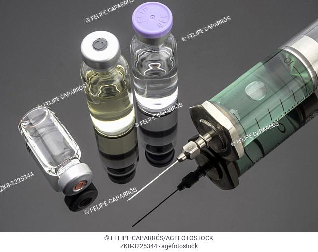 Syringe vintage next to vials, conceptual image