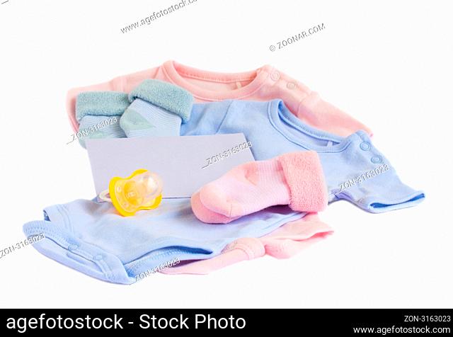 baby blue and pink apparel with blank envelope on white background