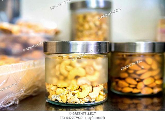 Close up jars with different nuts. Healthy food concept