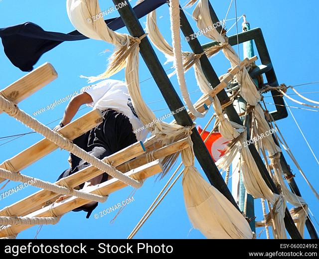 the masts of a ship and the sailor