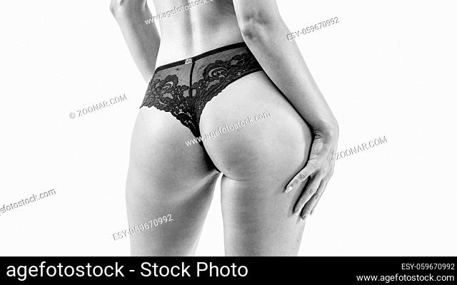 Round, strong, juicy ass in black body. Isolated on white
