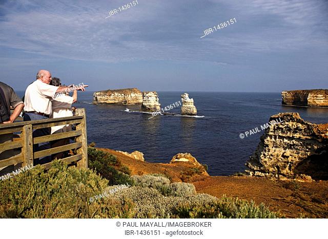 Tourists overlooking the Bay of Isles, Port Campbell National Park, Victoria, Australia