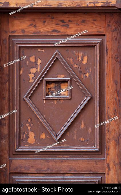 Detail of a wooden door with square and diamond pattern