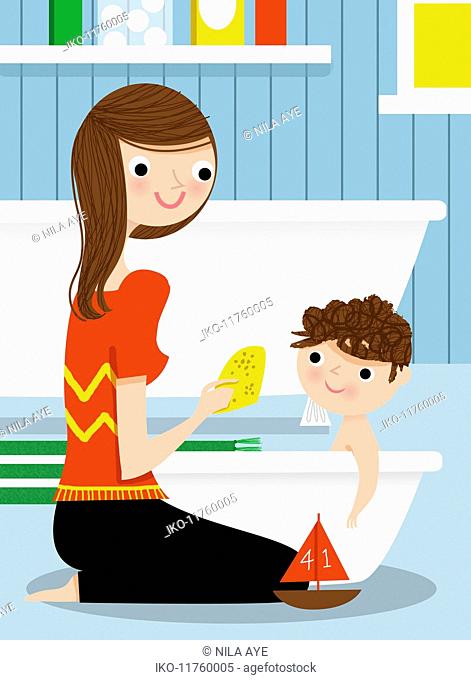 Mother bathing son in baby bathtub