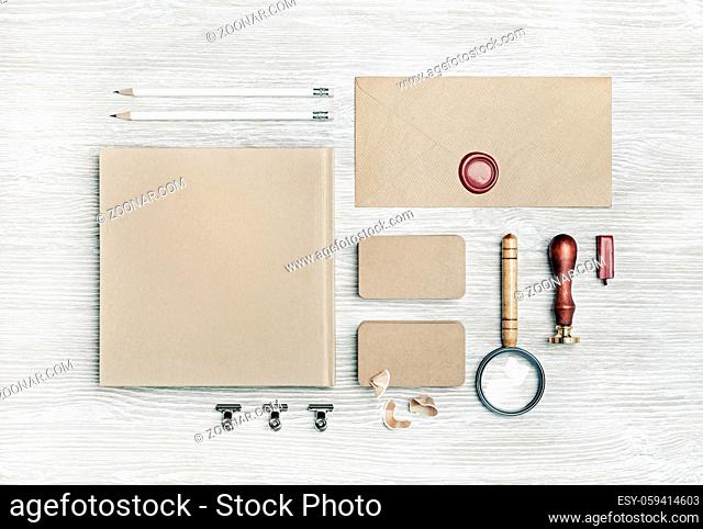 Blank vintage corporate stationery set on light wooden background. Branding mock up. Top view. Flat lay