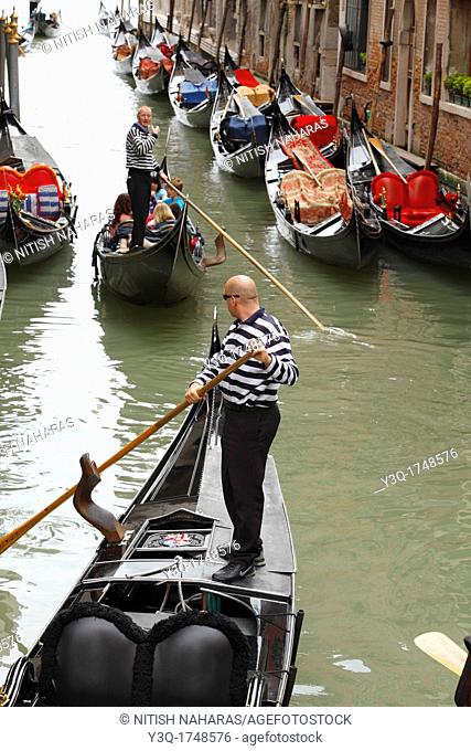 Gondoliers negotiating canal traffic in Venice, Italy