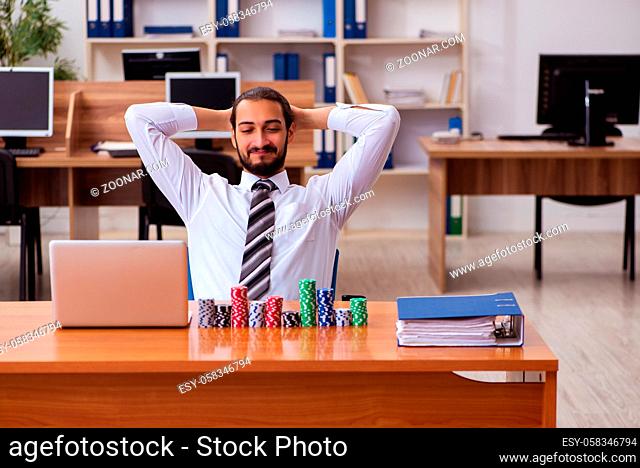 Young businessman employee in gambling concept
