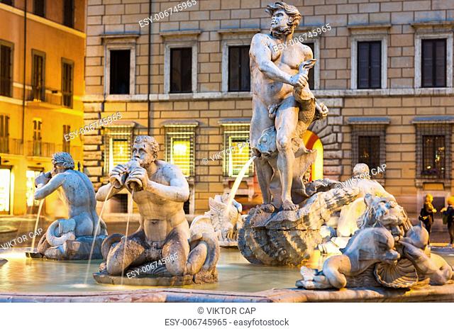 Northward view of the Piazza Navona with the fontana del Moro (the Moor Fountain) and the Sant'Agnese in Agone church at dusk - Rome, Italy