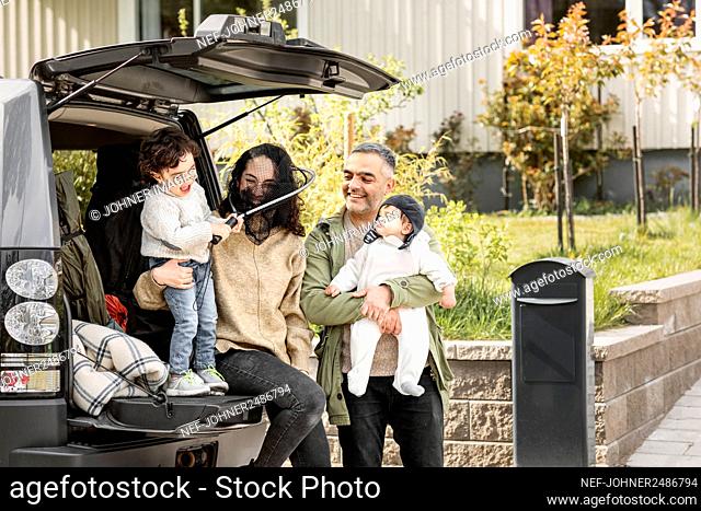 Parents with children near car