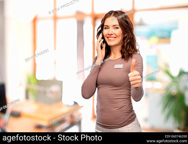 happy woman calling on smartphone at office