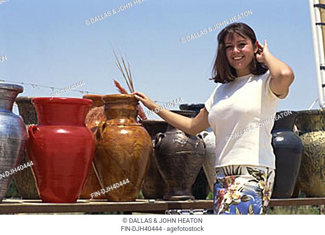 Israel, Young Woman presenting Pottery