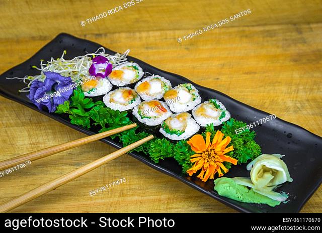 Perfect sushi, traditional Japanese cuisine. Delicious hossomaki on the decorated plate