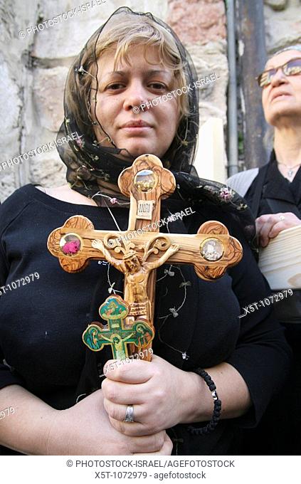Israel, Jerusalem The Via Dolorosa Procession, Good Friday, Easter 2007  Female pilgrim holding a crucifix
