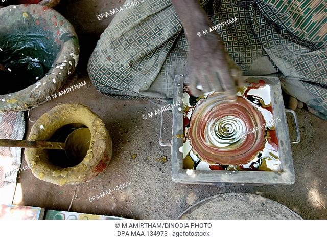 Man making Athangudi tiles which are not ceramic quite heavy and costly ; Tamil Nadu ; India