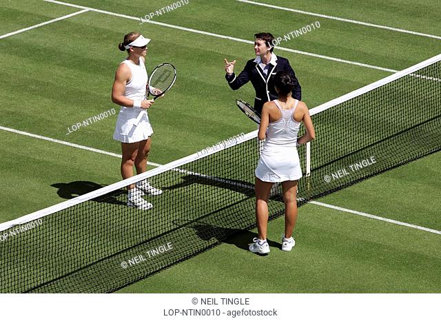 England, London, Wimbledon, The umpire tosses the coin before the start of a match during the Wimbledon Tennis Championships 2008