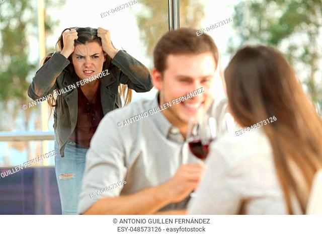 Disloyal boyfriend caught by his angry girlfriend dating with another girl in a restaurant