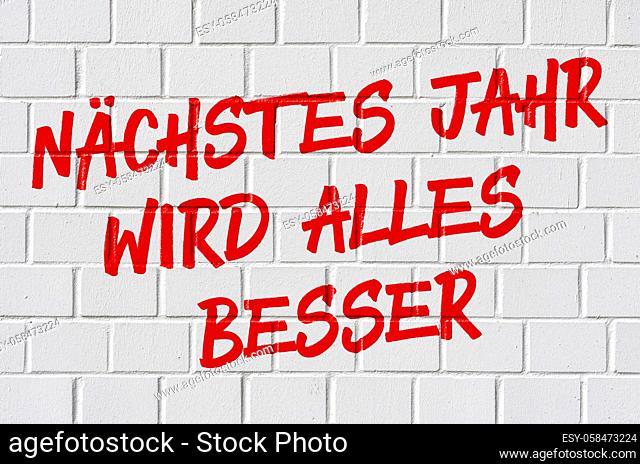 Graffiti on a brick wall - Next year everything will be better in german - Nächstes Jahr wird alles besser