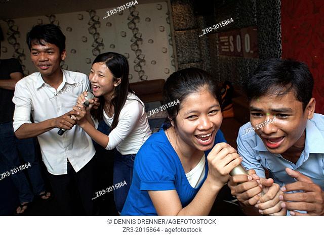 University students enjoy a night in a karaoke bar in Phnom Penh, Cambodia