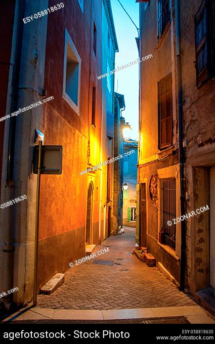 View of narrow alley in the early evening with lamp lit, in the lovely village of Rians. Located in Var department, Provence region, in southeastern France