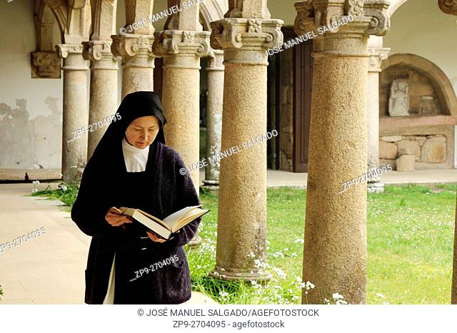 Nun reading in the cloister. Cistercian Monastery of Ferreira de Pantón, Lugo, Spain