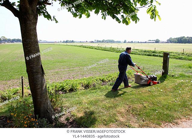 Farmer cutting grass, Netherlands